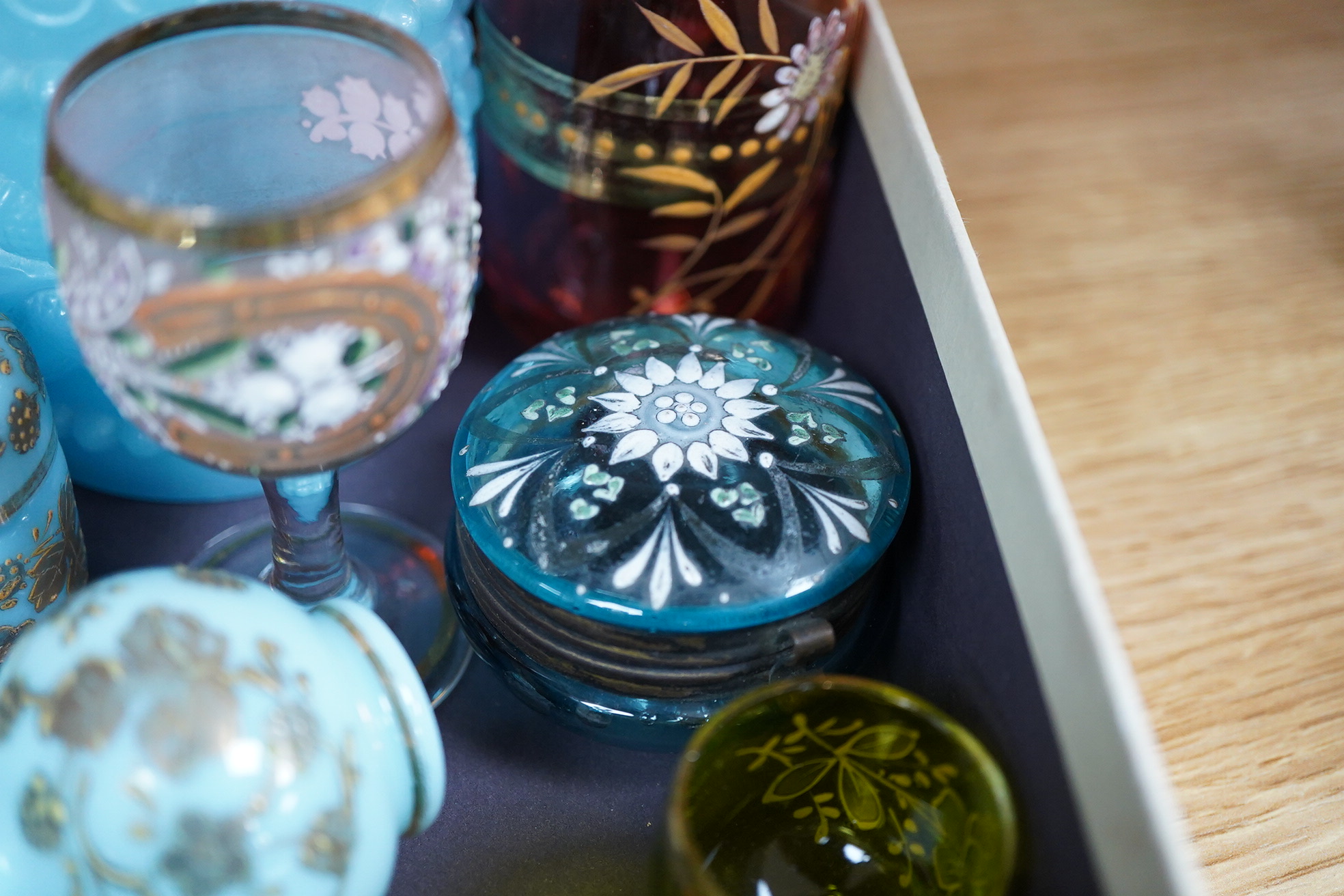 A collection of 19th century and later glassware to include gilt scent bottles, fruit ornaments and beakers, largest 14cm high